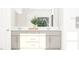 Modern bathroom with double sink vanity, white countertops, and a view of the outdoors at 1548 Bright Coral Trl, Wendell, NC 27591