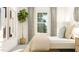 Bedroom with a fiddle leaf fig, modern art, and a view of the outdoors through a window at 1548 Bright Coral Trl, Wendell, NC 27591
