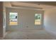 Bright bedroom with large windows providing ample natural light, awaiting personalization at 1609 Malcus Ct # 67, Fuquay Varina, NC 27526