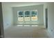 Bright, unfinished bedroom with multiple windows and natural light, awaiting flooring and paint at 1609 Malcus Ct # 67, Fuquay Varina, NC 27526