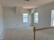 Bright, unfinished bonus room with sloped ceilings, multiple windows, and natural light at 1609 Malcus Ct # 67, Fuquay Varina, NC 27526