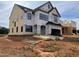 New construction featuring black trim windows and a two car garage on a large lot at 1609 Malcus Ct # 67, Fuquay Varina, NC 27526