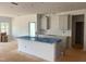 Modern kitchen featuring a central island with sink and stylish gray cabinets, ready for appliances at 1609 Malcus Ct # 67, Fuquay Varina, NC 27526