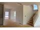 Bright living area with open staircase, perfect for customization with neutral paint and trim at 1609 Malcus Ct # 67, Fuquay Varina, NC 27526