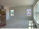 Bright living room area with large windows and unfinished floors, awaiting your design touch at 1609 Malcus Ct # 67, Fuquay Varina, NC 27526