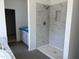 A newly installed shower features marble-style tiling and modern fixtures in this bathroom at 1609 Malcus Ct # 67, Fuquay Varina, NC 27526