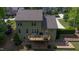 Expansive backyard featuring a deck with outdoor furniture and a charming brick patio with a fire pit at 1820 Yates Wheel Way, Raleigh, NC 27606