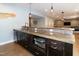 Wet bar with stylish backsplash, dark wood cabinets, and stainless steel oven at 1820 Yates Wheel Way, Raleigh, NC 27606