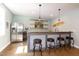 Basement bar area with wood counters, stainless steel refrigerator, and comfortable seating at 1820 Yates Wheel Way, Raleigh, NC 27606
