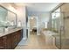 Bathroom showing a double vanity and granite countertop, and bathtub and shower combo with neutral tile at 1820 Yates Wheel Way, Raleigh, NC 27606