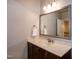 Bathroom vanity with marble countertop, dark wood cabinets, and a large framed mirror at 1820 Yates Wheel Way, Raleigh, NC 27606