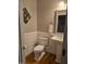 Cozy bathroom features a pedestal sink, toilet and wood look flooring at 1820 Yates Wheel Way, Raleigh, NC 27606