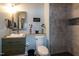 Basement bathroom features a vanity, toilet, and tiled shower at 1820 Yates Wheel Way, Raleigh, NC 27606