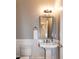 This bathroom features a pedestal sink, toilet, and mirror at 1820 Yates Wheel Way, Raleigh, NC 27606