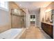 Bathroom featuring tile flooring, a glass enclosed shower and a soaking tub at 1820 Yates Wheel Way, Raleigh, NC 27606