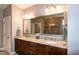 Bathroom showcasing double sink vanity, granite countertops, and a large mirror at 1820 Yates Wheel Way, Raleigh, NC 27606