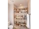 Bathroom shower with decorative curtain, shower rod, towel rack, toilet and tan tile at 1820 Yates Wheel Way, Raleigh, NC 27606