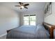 Comfortable bedroom features a ceiling fan and a window overlooking the backyard at 1820 Yates Wheel Way, Raleigh, NC 27606