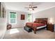 A bedroom with a large bed, neutral colored carpet and 2 windows at 1820 Yates Wheel Way, Raleigh, NC 27606