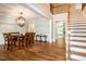 Formal dining room featuring hardwood floors, wainscotting and statement light fixture at 1820 Yates Wheel Way, Raleigh, NC 27606