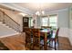 Dining room with hardwood floors, wooden table, and a staircase view, perfect for Gathering meals at 1820 Yates Wheel Way, Raleigh, NC 27606