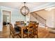 Inviting dining area showcases hardwood floors and staircase at 1820 Yates Wheel Way, Raleigh, NC 27606