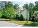 Beautiful two-story home with a well-manicured lawn, lush landscaping, and a charming exterior at 1820 Yates Wheel Way, Raleigh, NC 27606