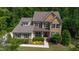 Aerial view of a charming two-story house with well-maintained landscaping and a welcoming front porch at 1820 Yates Wheel Way, Raleigh, NC 27606