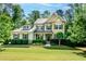 Charming two-story home featuring a well-manicured lawn and lush landscaping at 1820 Yates Wheel Way, Raleigh, NC 27606