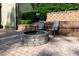A cozy outdoor fire pit surrounded by chairs sits on a paved patio, perfect for gatherings at 1820 Yates Wheel Way, Raleigh, NC 27606