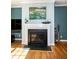 Stylish fireplace with black trim, hardwood floors, and elegant decor enhancing the room's ambiance at 1820 Yates Wheel Way, Raleigh, NC 27606