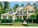 Charming two-story home featuring a well-manicured lawn and inviting curb appeal with lush landscaping at 1820 Yates Wheel Way, Raleigh, NC 27606