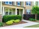 Inviting front porch with lush greenery and stone accents, perfect for relaxing outdoors at 1820 Yates Wheel Way, Raleigh, NC 27606