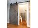 Finished hallway with barn door leading to storage area with additional barn door at 1820 Yates Wheel Way, Raleigh, NC 27606