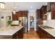 The kitchen features stainless steel appliances, granite countertops, dark wood cabinetry, and a walk-in pantry at 1820 Yates Wheel Way, Raleigh, NC 27606