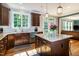 Bright kitchen featuring granite countertops, hardwood floors, dark cabinets, and stainless steel appliances at 1820 Yates Wheel Way, Raleigh, NC 27606
