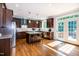 Spacious kitchen featuring dark wood cabinets, stainless steel appliances, and a center island with bar stools at 1820 Yates Wheel Way, Raleigh, NC 27606