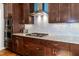Kitchen featuring stainless steel appliances, granite counters, a gas cooktop, and hardwood floors at 1820 Yates Wheel Way, Raleigh, NC 27606