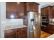 Kitchen area featuring stainless appliances, granite countertops, and wood cabinets at 1820 Yates Wheel Way, Raleigh, NC 27606