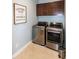 The laundry room features a washer, dryer, and cabinetry at 1820 Yates Wheel Way, Raleigh, NC 27606