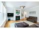 Relaxing living room featuring hardwood floors, fireplace, and natural light at 1820 Yates Wheel Way, Raleigh, NC 27606
