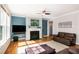 Cozy living room with a fireplace, hardwood floors, and comfortable seating perfect for relaxing at 1820 Yates Wheel Way, Raleigh, NC 27606