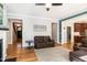 Living room featuring hardwood floors, neutral colors, and views of the front entry and eat-in kitchen at 1820 Yates Wheel Way, Raleigh, NC 27606