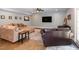 Finished basement living room with a large sectional sofa and a ceiling fan at 1820 Yates Wheel Way, Raleigh, NC 27606