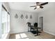 Bright home office featuring a modern desk, natural light from windows, and decorative wall art at 1820 Yates Wheel Way, Raleigh, NC 27606