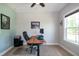 A well-lit office has a wood desk and a comfortable black office chair in this carpeted room at 1820 Yates Wheel Way, Raleigh, NC 27606
