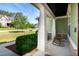 Inviting front porch with rocking chair and verdant landscaping at 1820 Yates Wheel Way, Raleigh, NC 27606