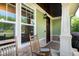 Cozy front porch featuring rocking chairs and stone accents at 1820 Yates Wheel Way, Raleigh, NC 27606