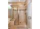 Shower with decorative tile and frameless door and large showerhead, plus a soaking tub with tile surround at 1820 Yates Wheel Way, Raleigh, NC 27606