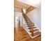 Elegant staircase with hardwood steps and iron railing leading to the upper level at 1820 Yates Wheel Way, Raleigh, NC 27606